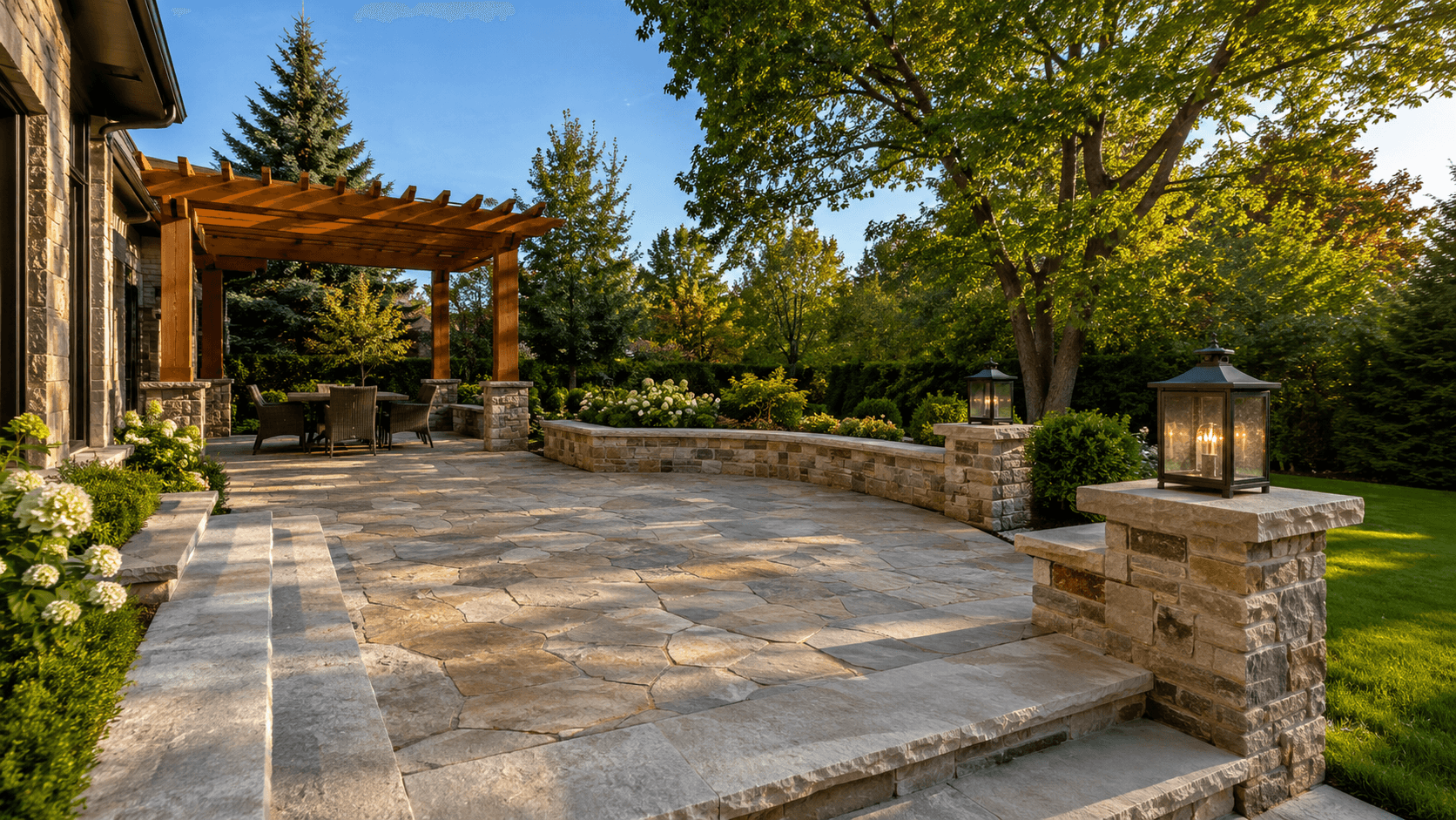Natural stone patio with seating wall and stone pillars in Oakville by McCoy Landscape Group